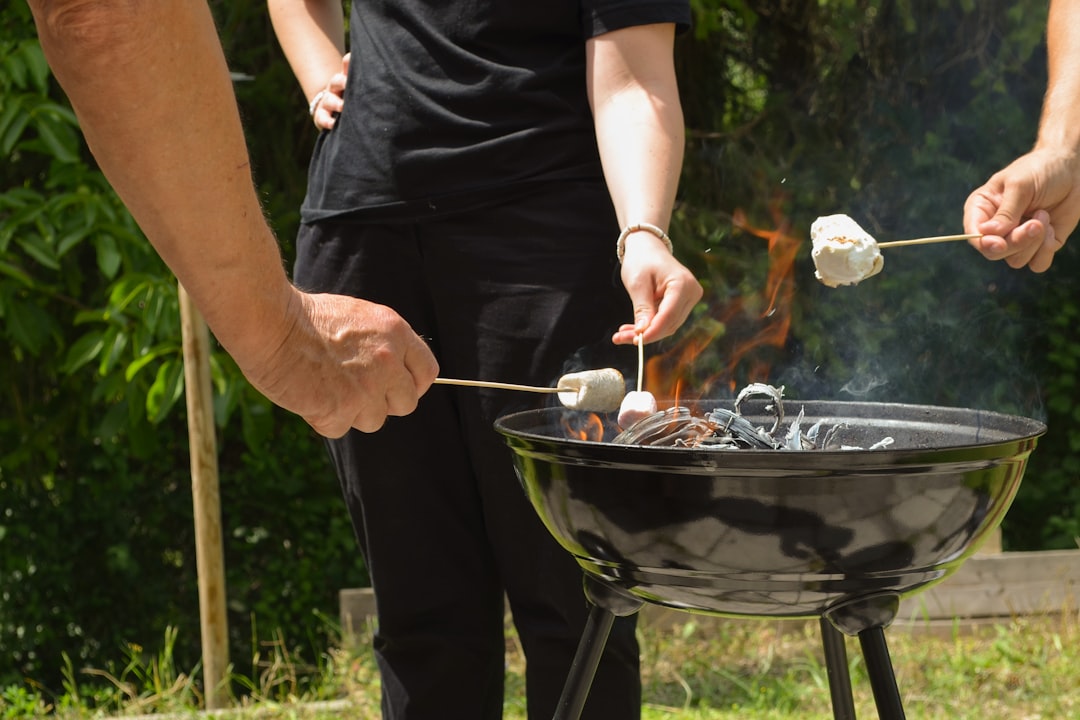 People roasting marshmallows over a barbecue grill