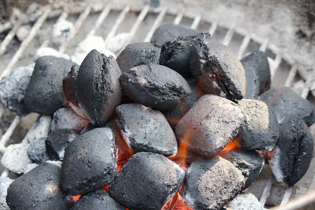 a close up of a grill with hot coals on it